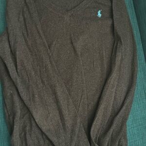 Dark grey v-neck sweater.